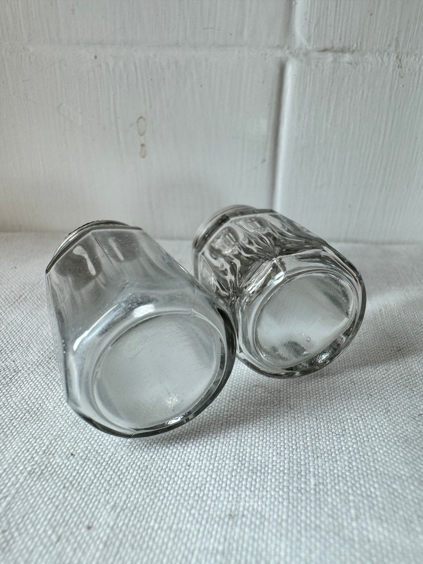 Pair of antique/vintage sterling silver topped salt and pepper pots with faceted glass