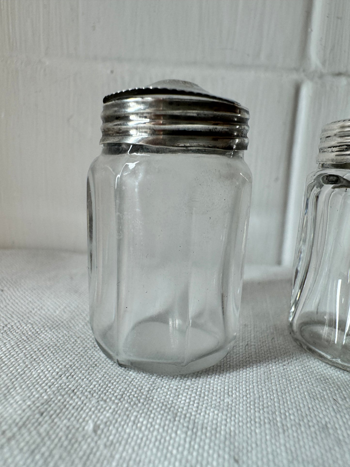 Pair of antique/vintage sterling silver topped salt and pepper pots with faceted glass
