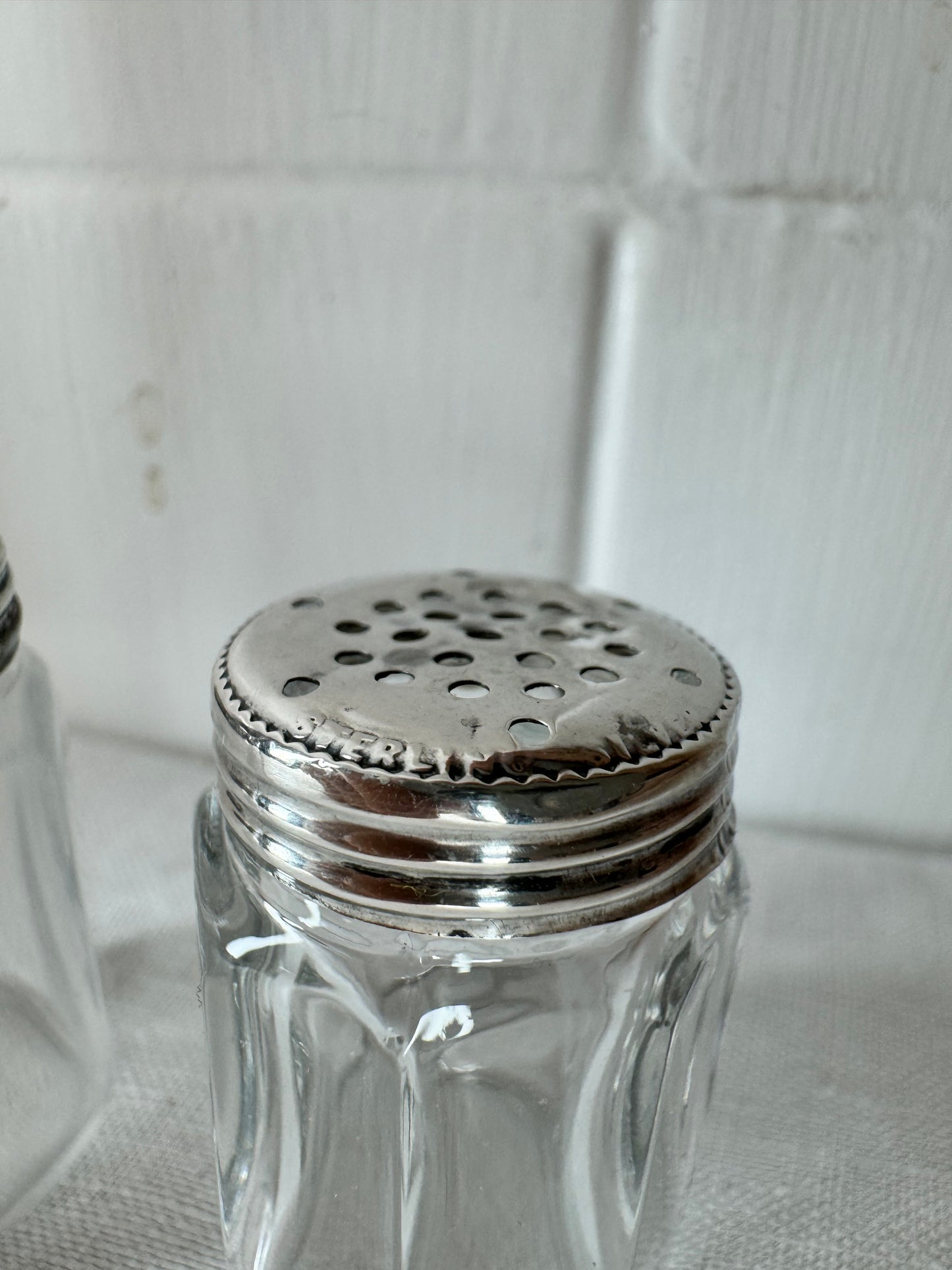 Pair of antique/vintage sterling silver topped salt and pepper pots with faceted glass
