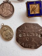 Lot 44: A collection of badges / pendants (estimate £20)