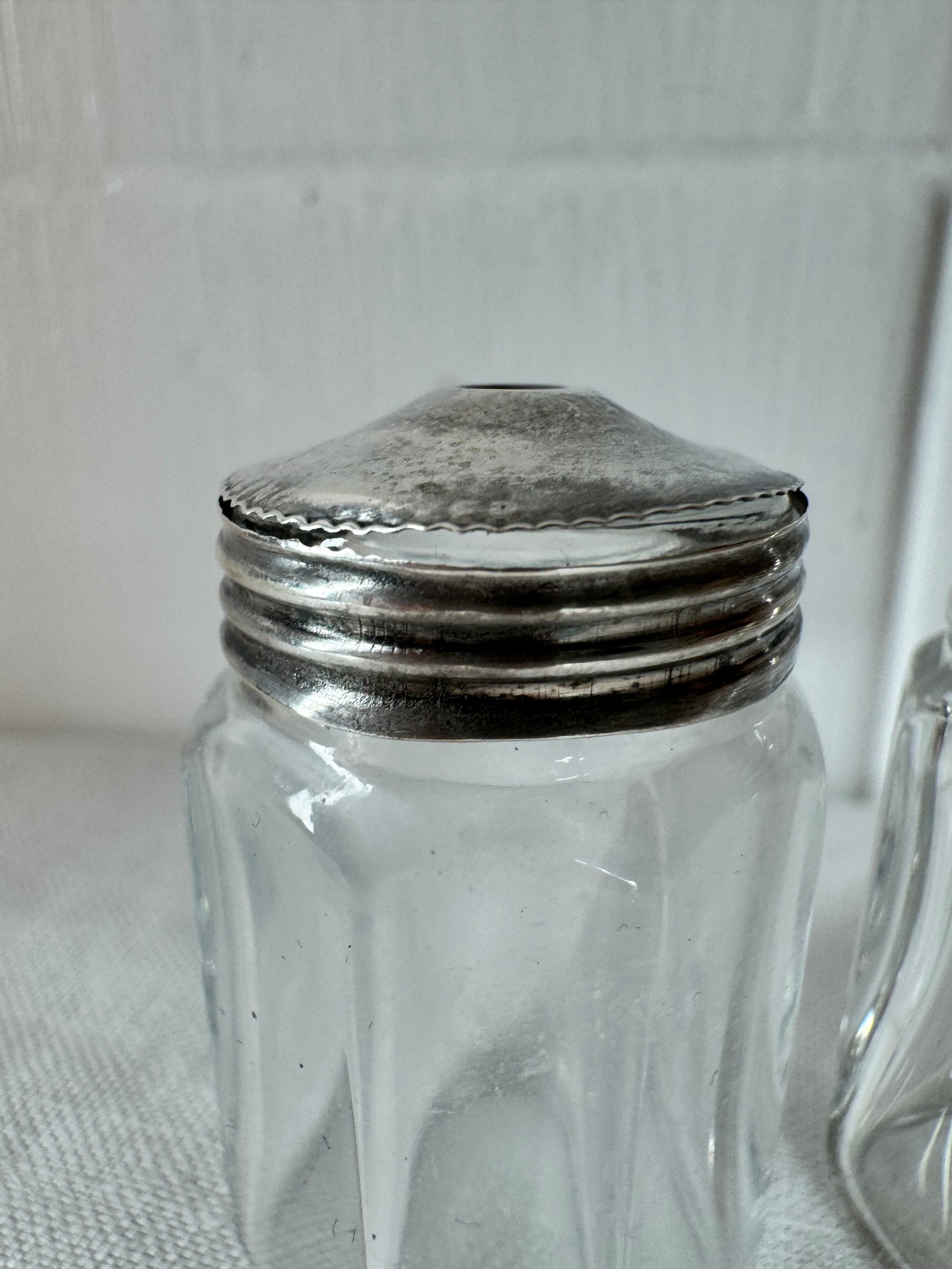 Pair of antique/vintage sterling silver topped salt and pepper pots with faceted glass