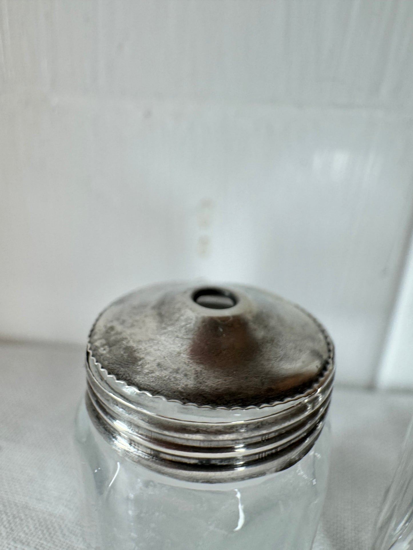 Pair of antique/vintage sterling silver topped salt and pepper pots with faceted glass