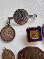 Lot 44: A collection of badges / pendants (estimate £20)
