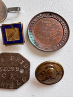 Lot 44: A collection of badges / pendants (estimate £20)
