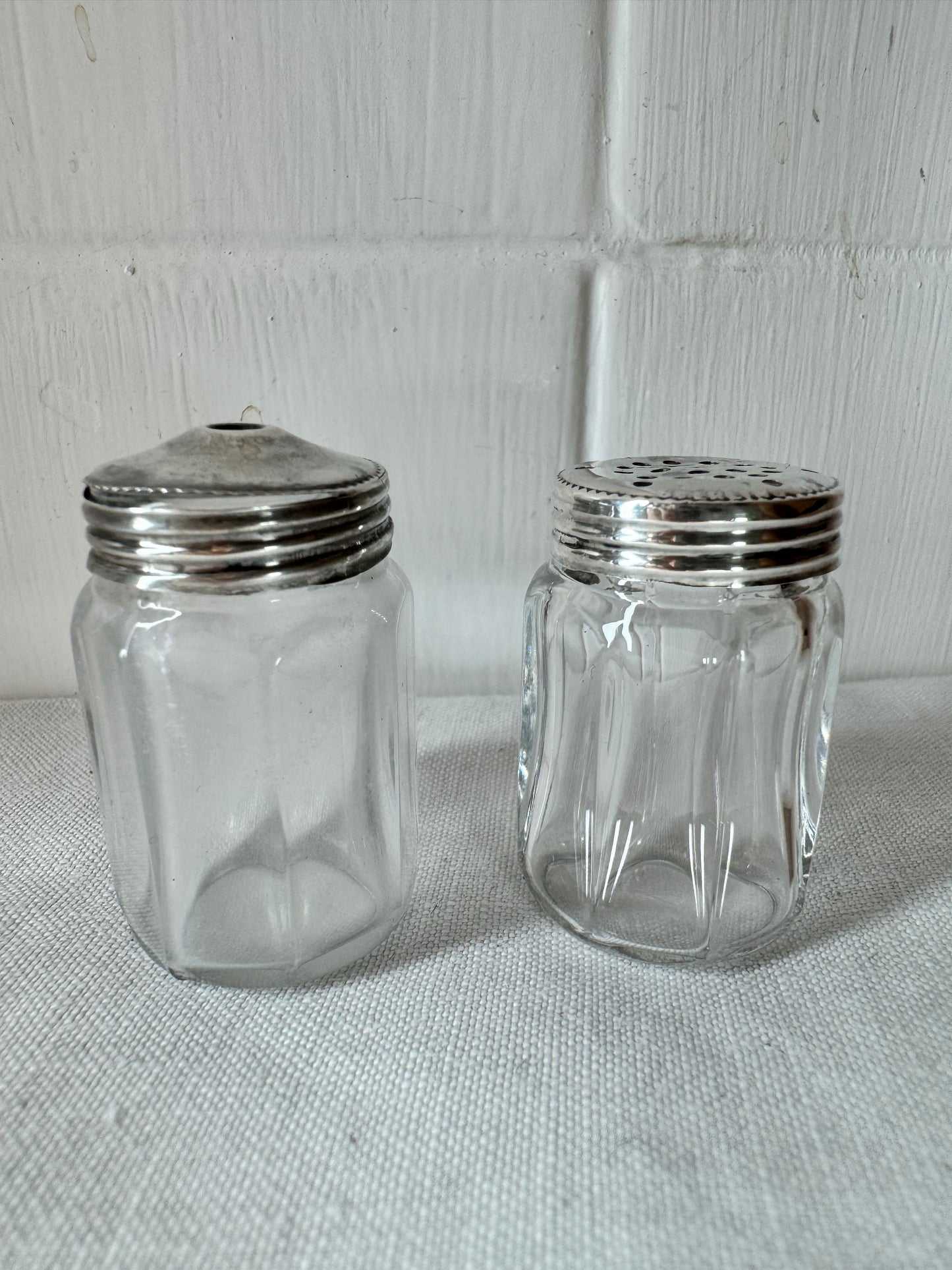 Pair of antique/vintage sterling silver topped salt and pepper pots with faceted glass