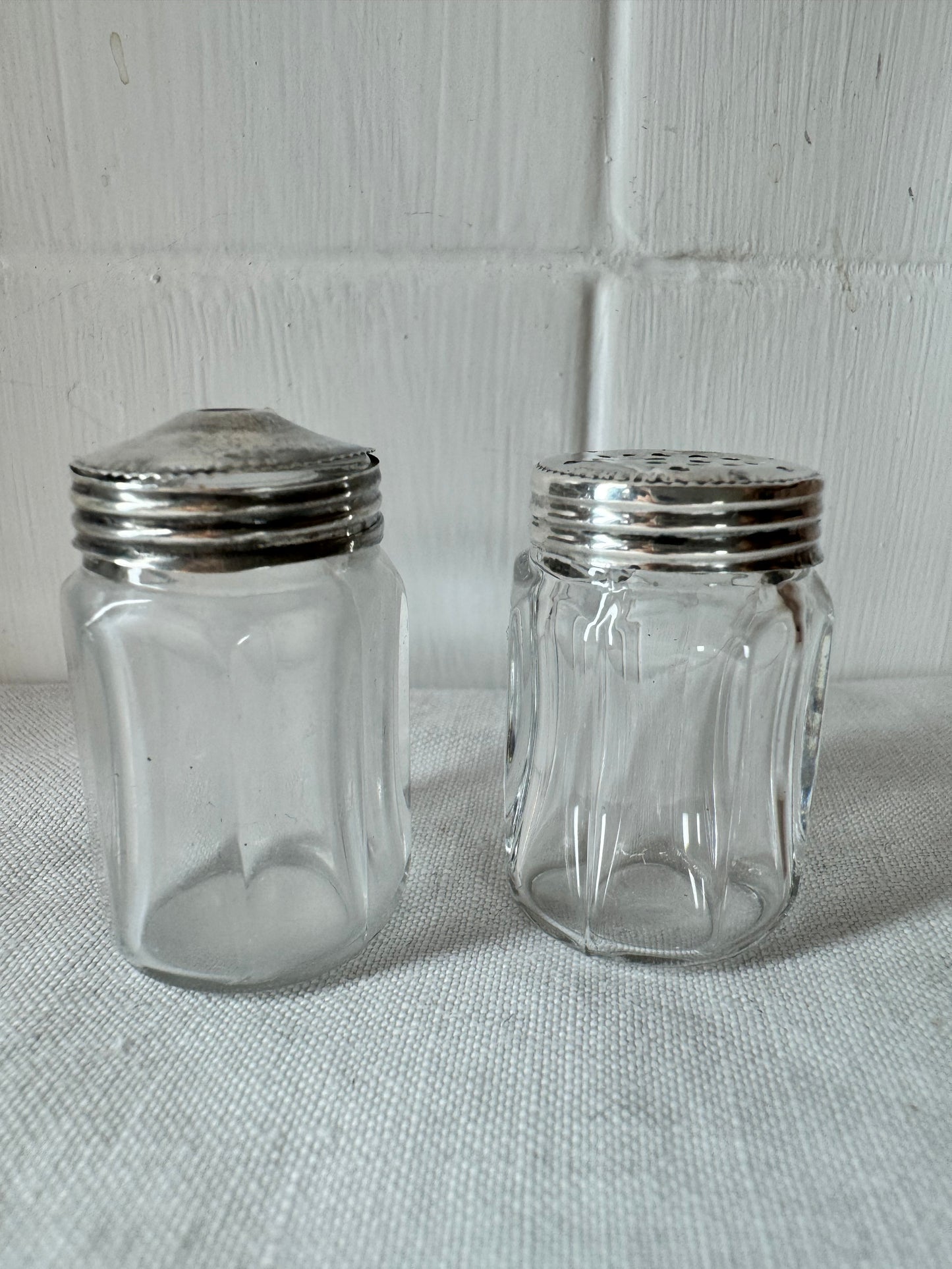 Pair of antique/vintage sterling silver topped salt and pepper pots with faceted glass